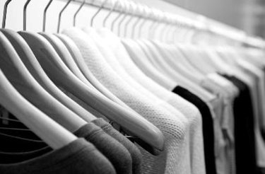 Hanger bar from the retail industry with clothes in black and white colours