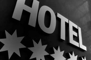 close up of hotel logo with the text ‘hotel’ and 5 stars underneath