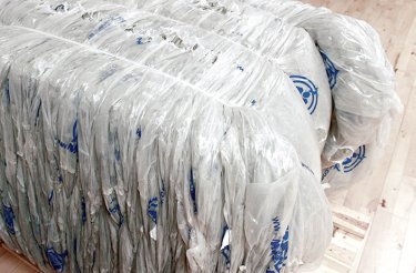 Plastic bale with strapping