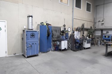 baler against wall in work environment