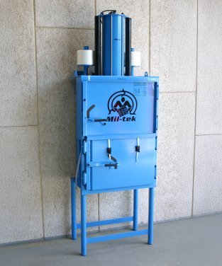 Blue Mil-tek 102 baler standing on the floor (used)