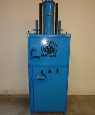 blue used baler on dark floor