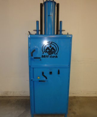 blue used baler on dark floor