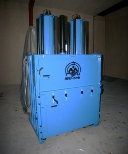 large blue baler standing in dark room